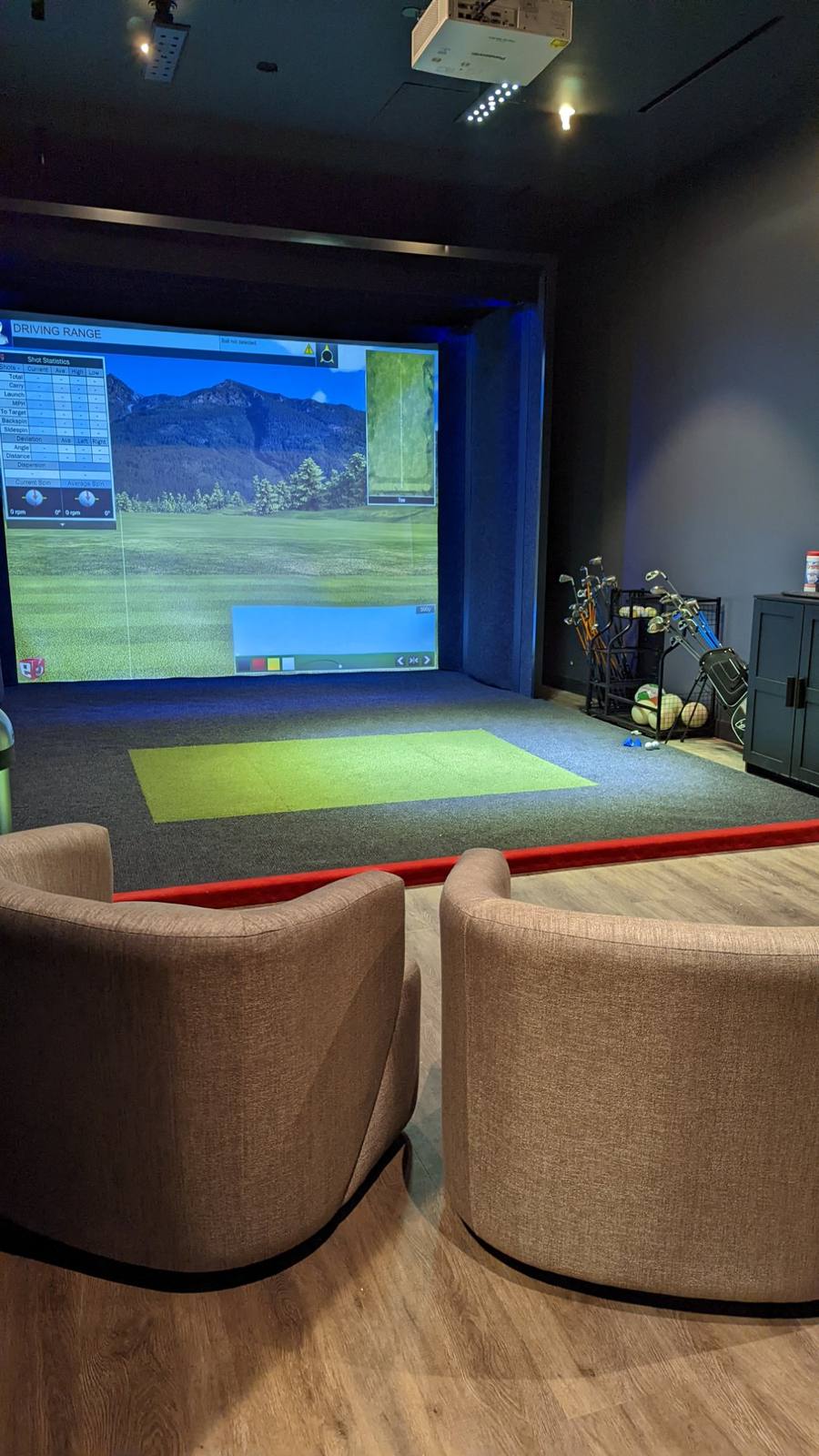 Altea Active Topgolf Swing Suite, two armchairs facing the simulator screen