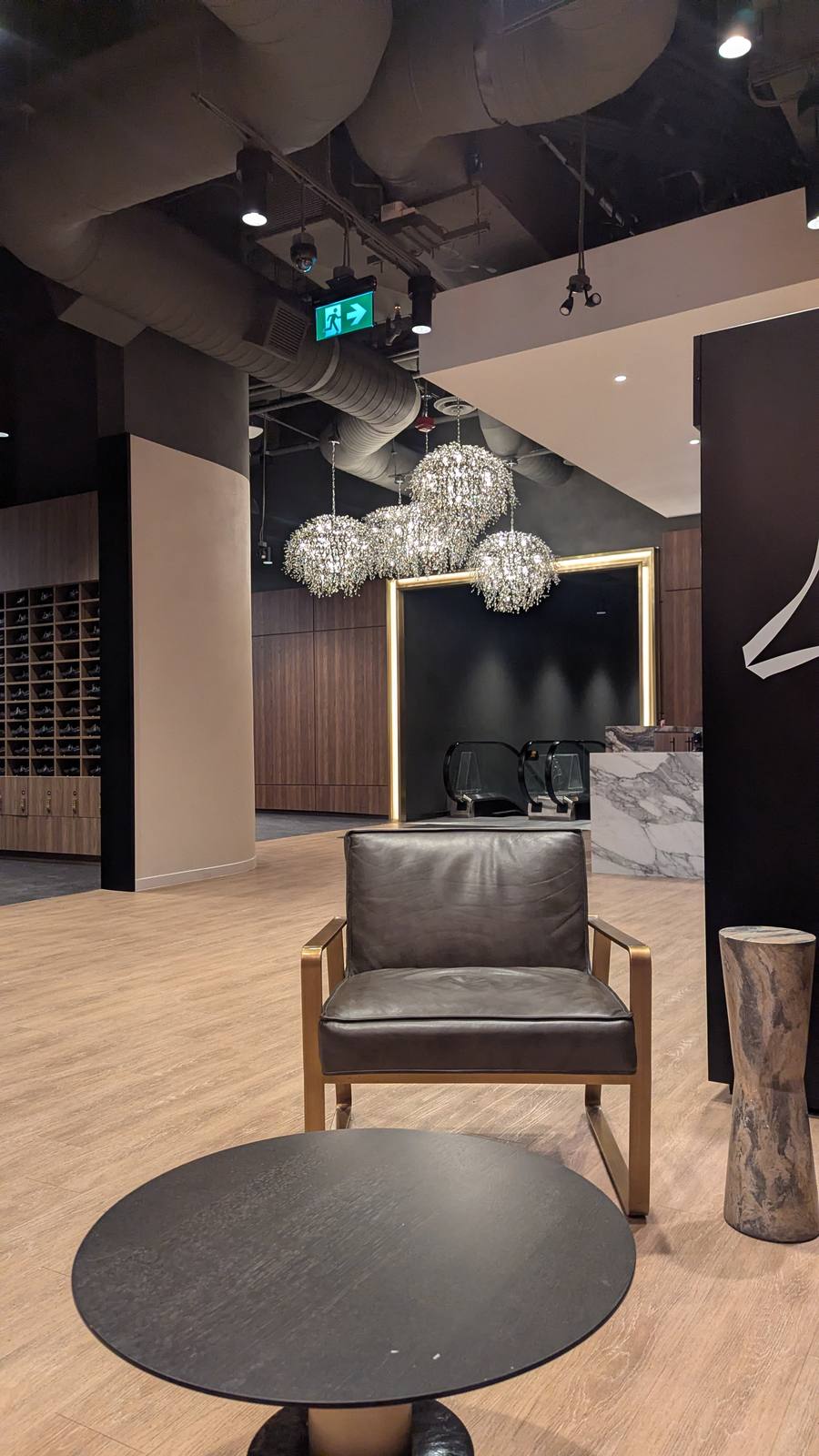 Avant Toronto entrance lounge, leather chair, gold framed mirror, crystal chandeliers